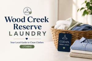 A laundry service sign sits next to a wicker basket of folded towels and shirts, with a green plant in the background.