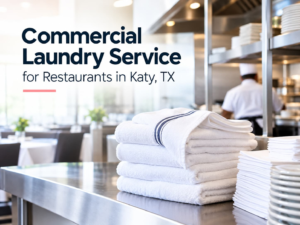A stack of folded white restaurant linens on a stainless steel counter, with text that reads: “Commercial Laundry Service for Restaurants in Katy, TX.”